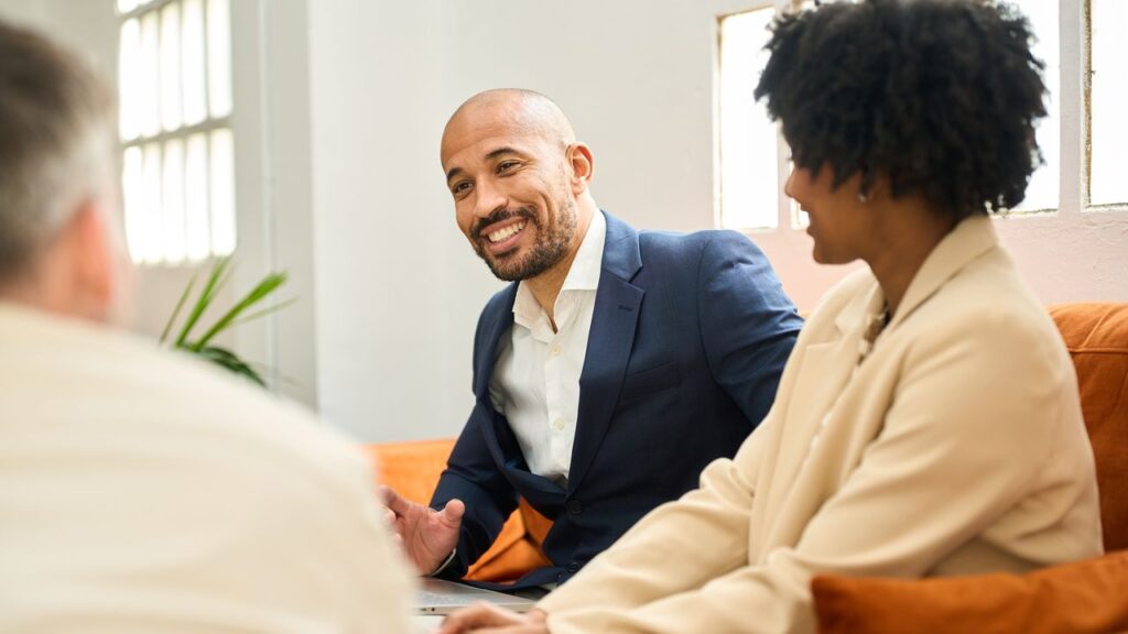 Financial advisor consulting a couple about loan options in coworking space
