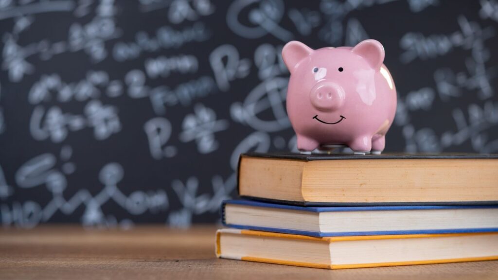 Female putting coin into piggy bank