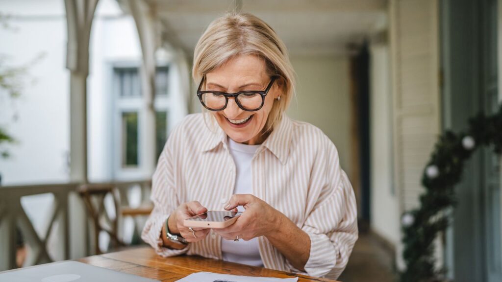 mature woman have contact less payment scan bill on mobile phone