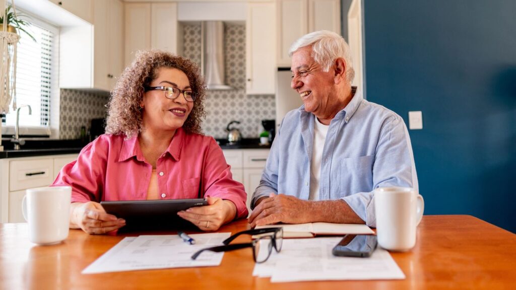 Senior couple talking and doing home finance