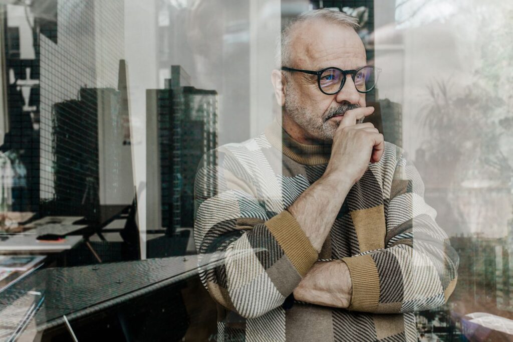 Senior man thinking by window