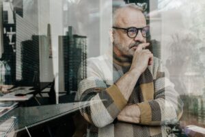 Senior man thinking by window