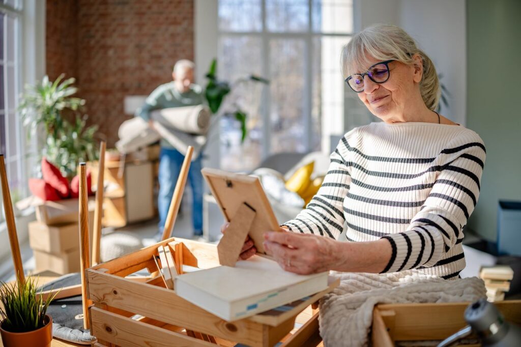 Senior couple enjoys a joyful moment while decorating their new home together indoors