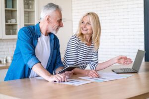Mature wife and husband checking documents with tax, pension savings