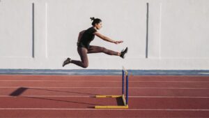 Female hurdler during training on tartan track